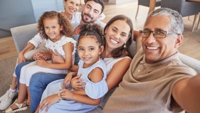 Selfie, family and children with a grandfather taking a photograph of his grandchildren and parents at home. Kids, love and grandparents with a man and his relatives in the living room for a photo.